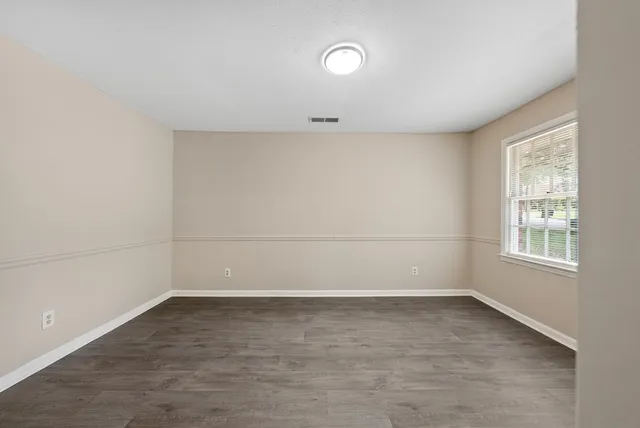 a view of a room with wooden floor