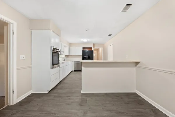 a view of a kitchen with a sink and a refrigerator
