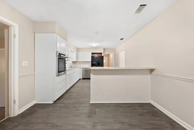a view of a kitchen with a sink and a refrigerator