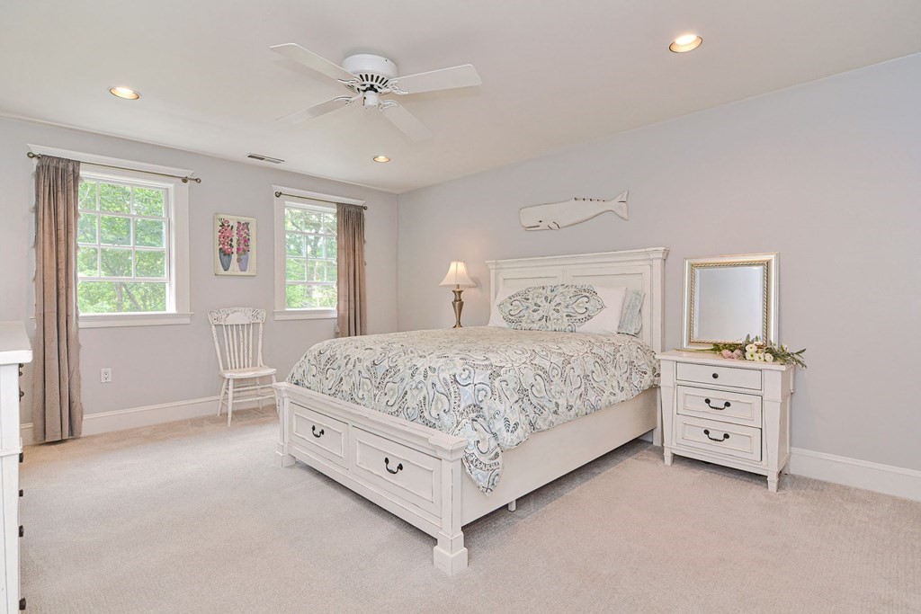 40 Brooks Station Road Princeton, MA 01541 - Photo 27 of 42 a bedroom with a large bed and a chandelier fan