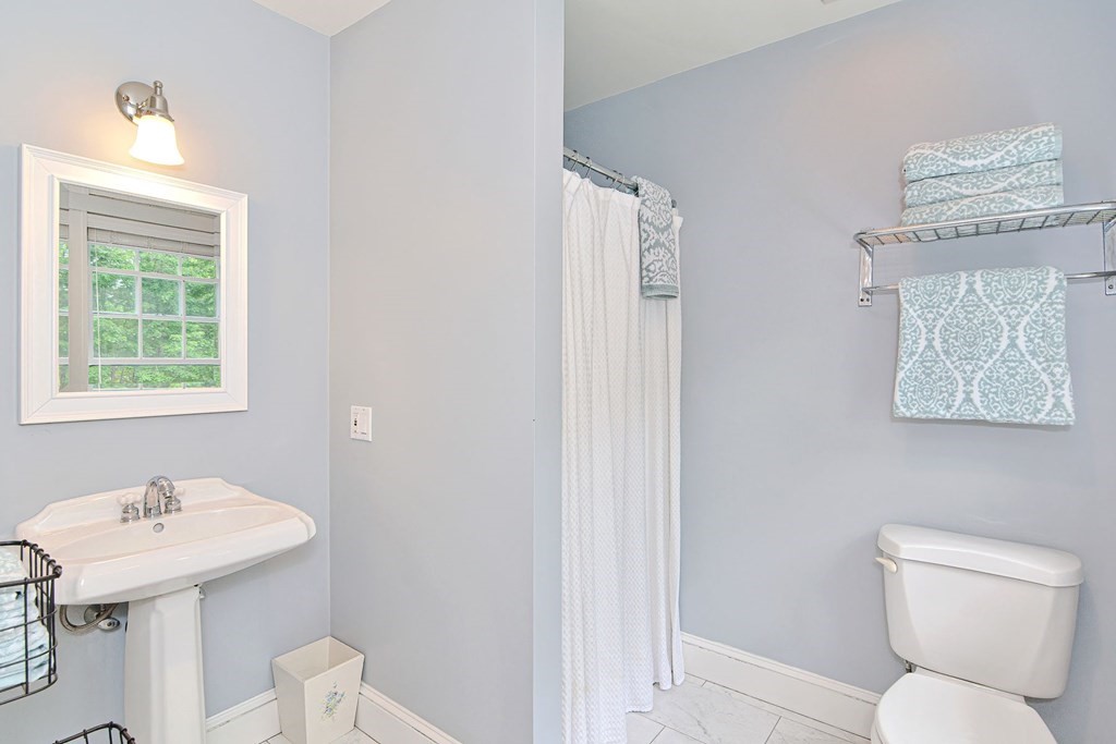 40 Brooks Station Road Princeton, MA 01541 - Photo 29 of 42 a bathroom with a toilet a sink and a window