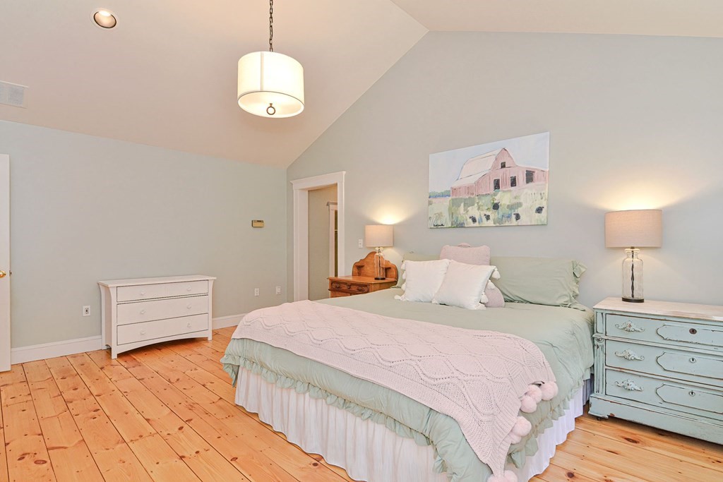 40 Brooks Station Road Princeton, MA 01541 - Photo 31 of 42 a bedroom with a bed and a chandelier