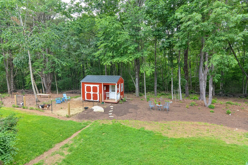 40 Brooks Station Road Princeton, MA 01541 - Photo 39 of 42 a backyard of a house with table and chairs