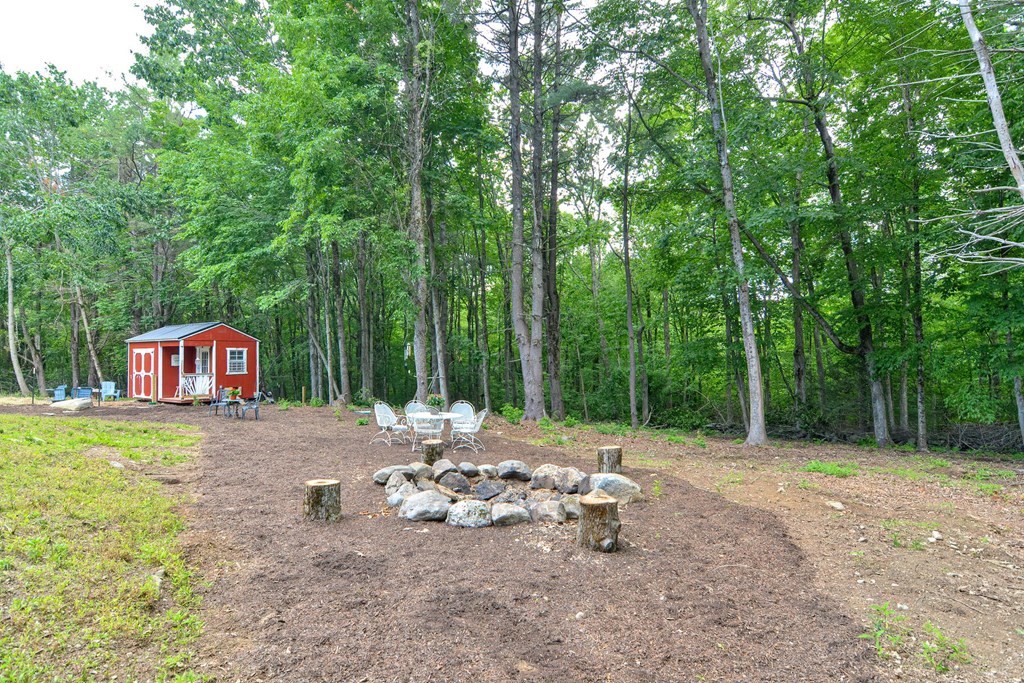 40 Brooks Station Road Princeton, MA 01541 - Photo 40 of 42 a view of a fire pit with large trees