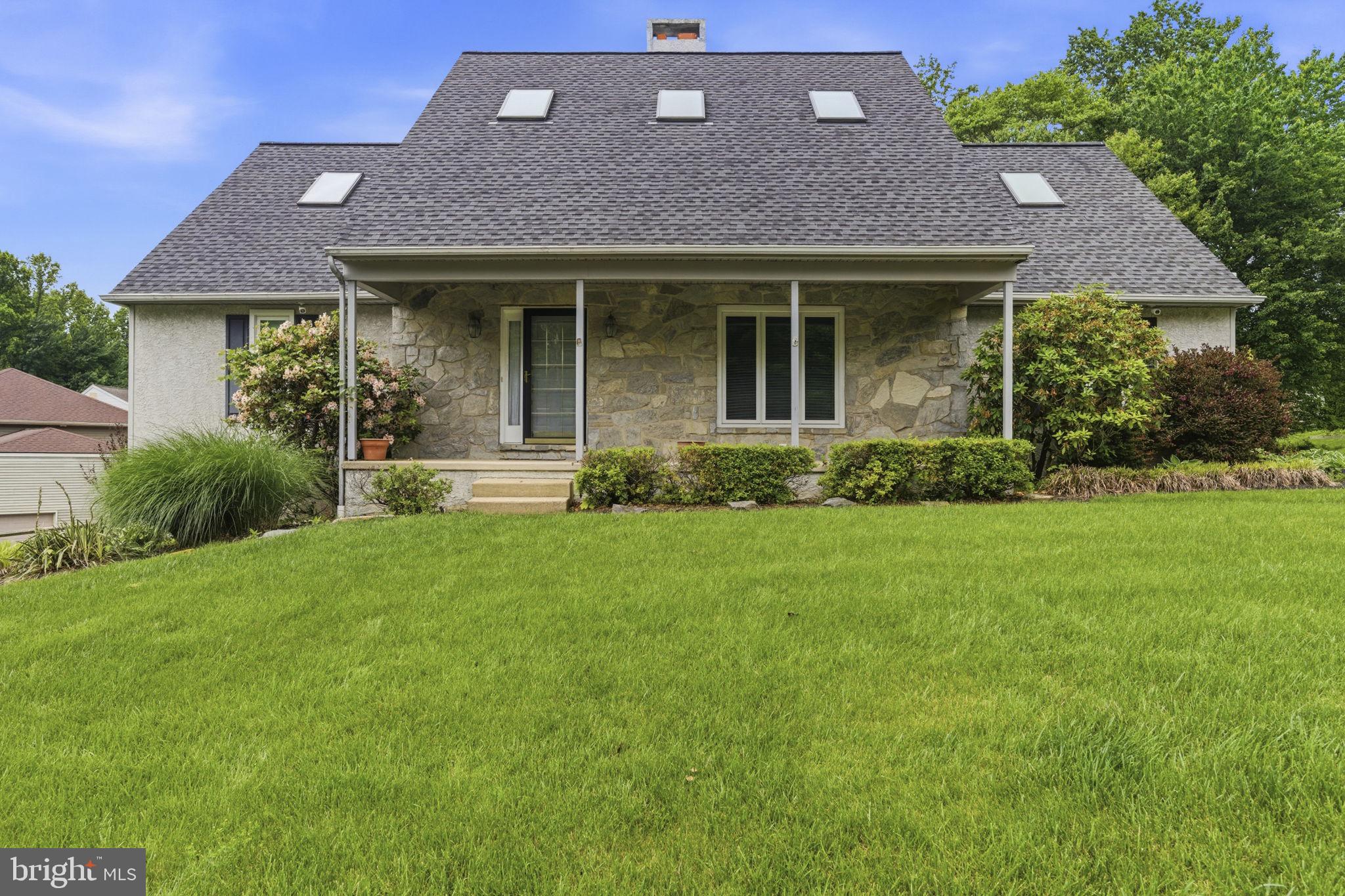 736 Letitia Drive Hockessin, DE 19707 - Photo 4 of 92 a front view of a house with a yard