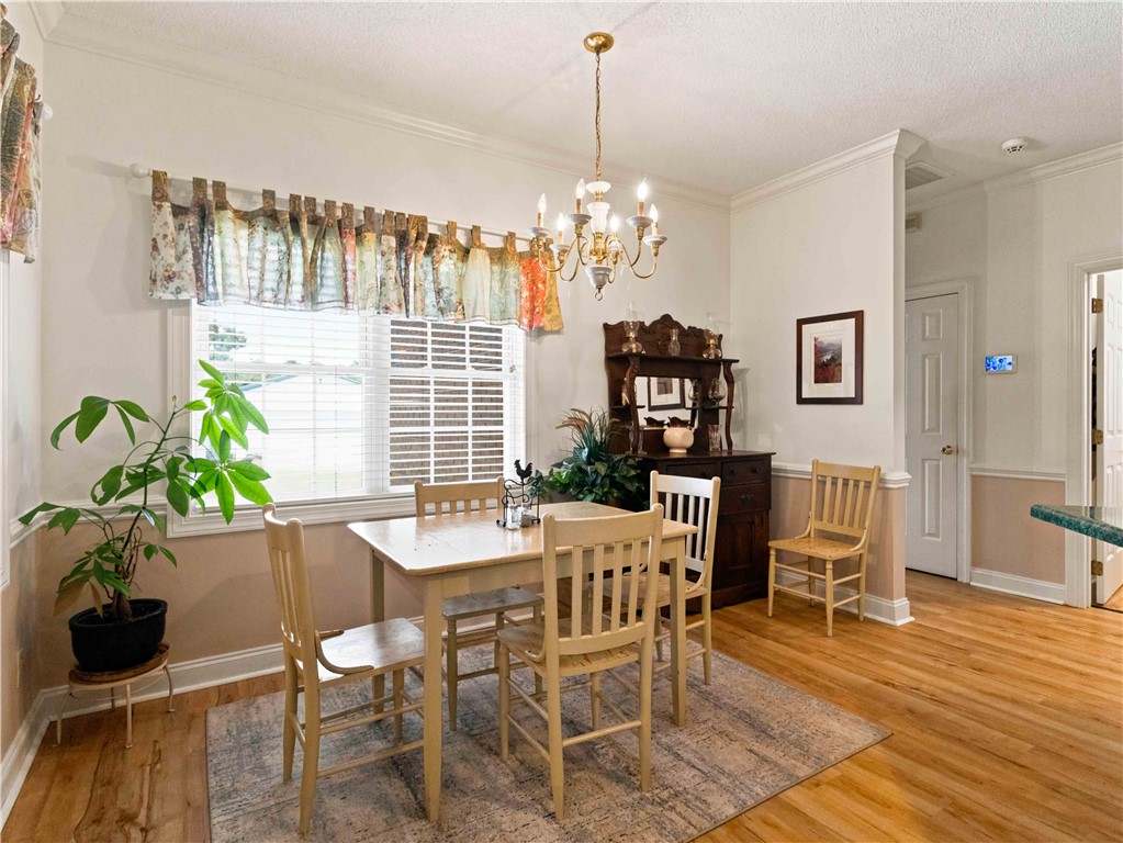 2861 Fairview Road Simpsonville, SC 29680 - Photo 15 of 42 Rich hardwood floors and classic crown molding elevate this welcoming dining space.