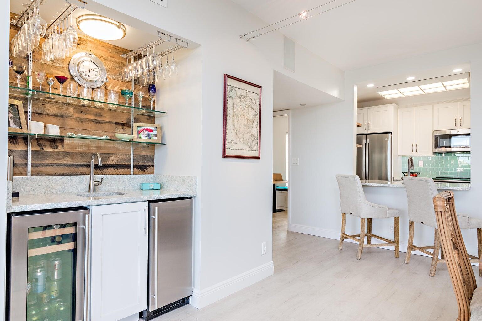 16940 Bay Street, Unit N406 Jupiter, FL 33477 - Photo 11 of 20 a open kitchen with stainless steel appliances granite countertop a sink and a refrigerator