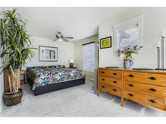 a bedroom with a bed dresser and a window