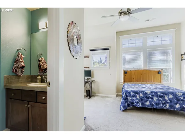 a bedroom with a bed a mirror and a window