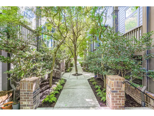 a view of a pathway with a wrought fence