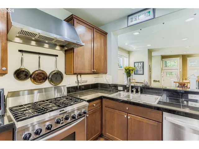 a kitchen with a stove a sink and cabinets