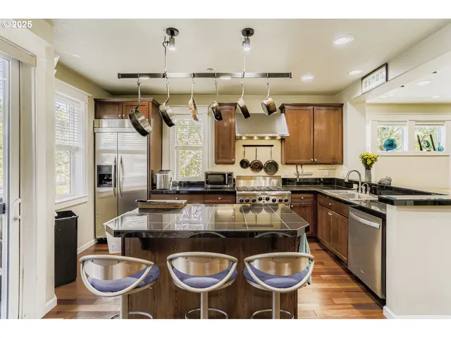 a kitchen with a stove a sink and a wooden cabinets