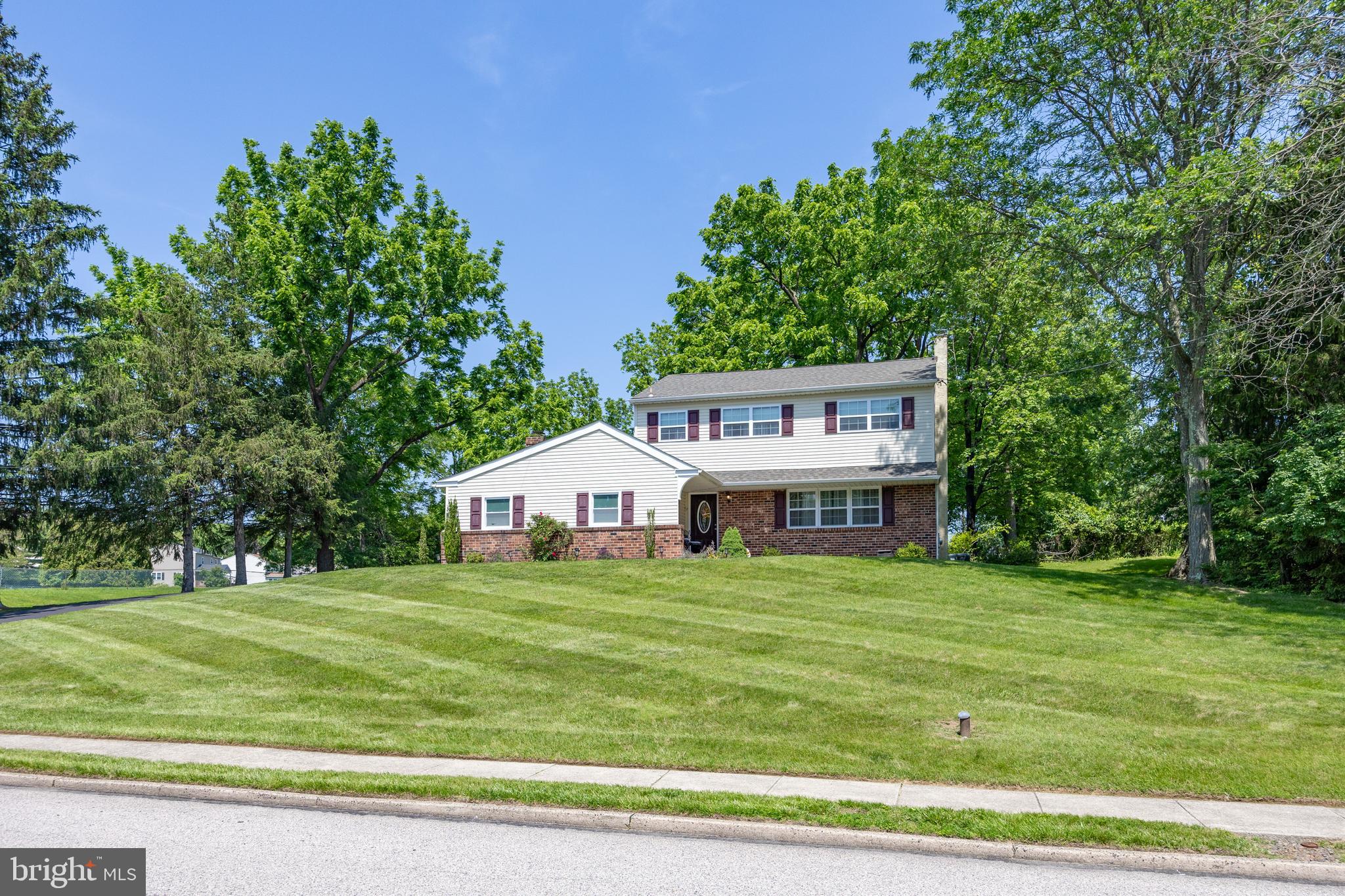 926 Pierce Road Norristown, PA 19403 - Photo 1 of 54 a view of a house with a big yard and large trees