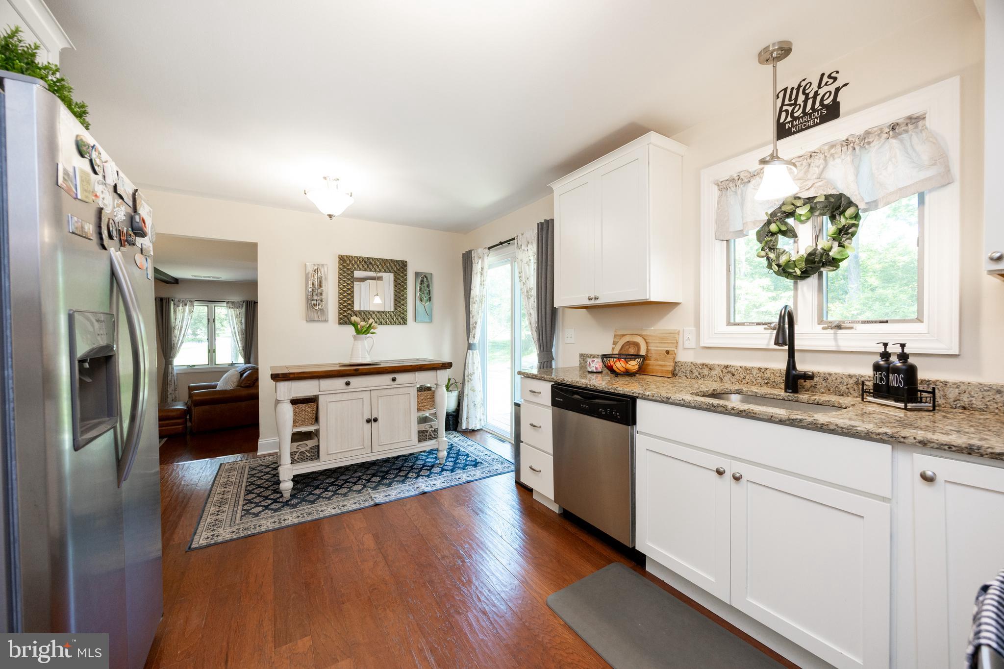 926 Pierce Road Norristown, PA 19403 - Photo 13 of 54 a kitchen with stainless steel appliances granite countertop a stove a sink and a refrigerator