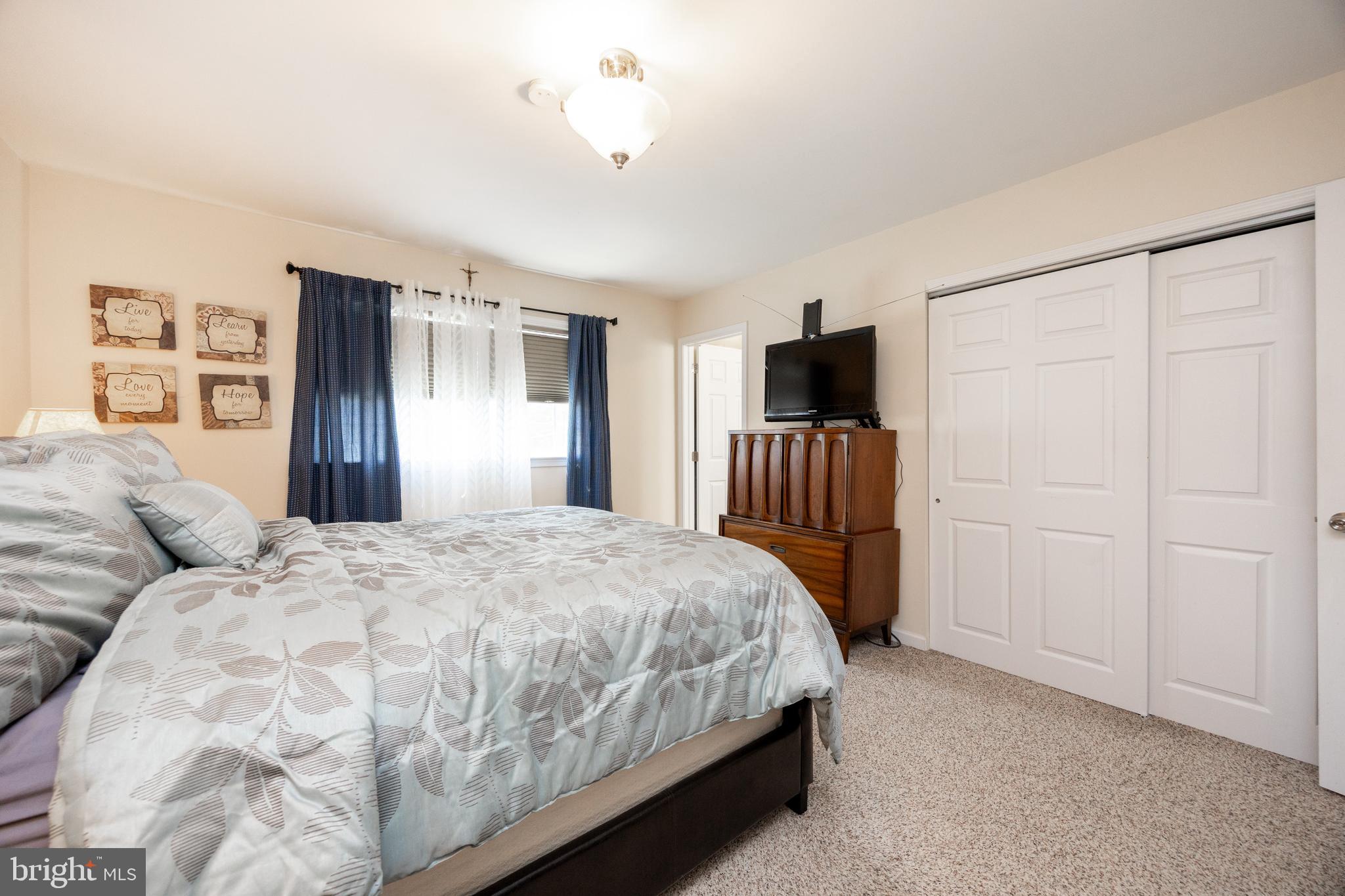 926 Pierce Road Norristown, PA 19403 - Photo 25 of 54 a bedroom with a bed and a flat tv screen