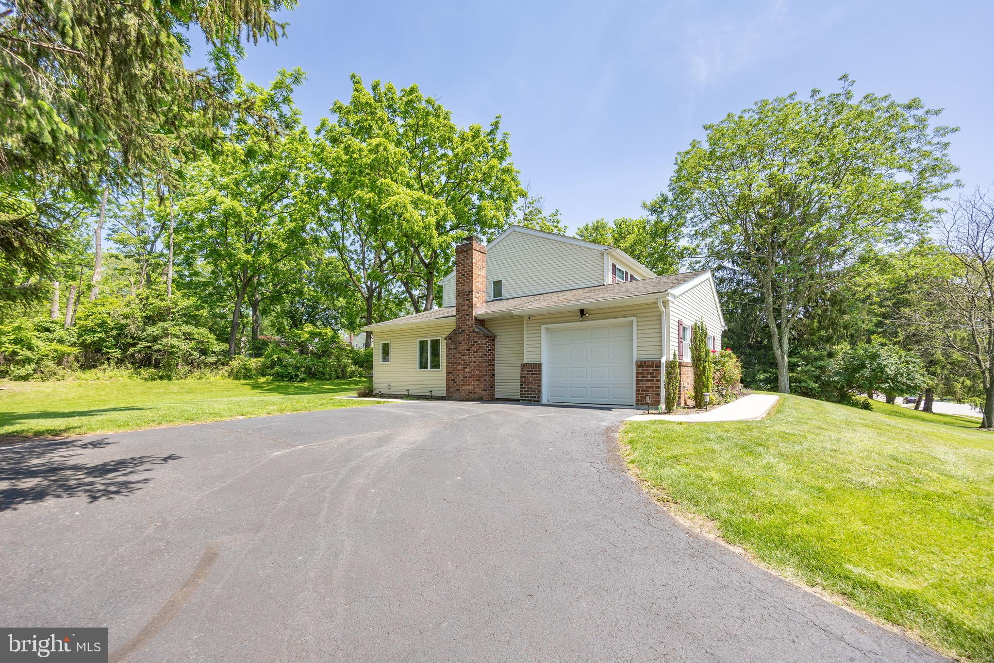 926 Pierce Road Norristown, PA 19403 - Photo 46 of 54 a front view of a house with a yard and garage