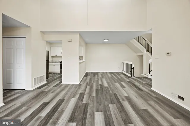a view of a kitchen with wooden floor and electronic appliances