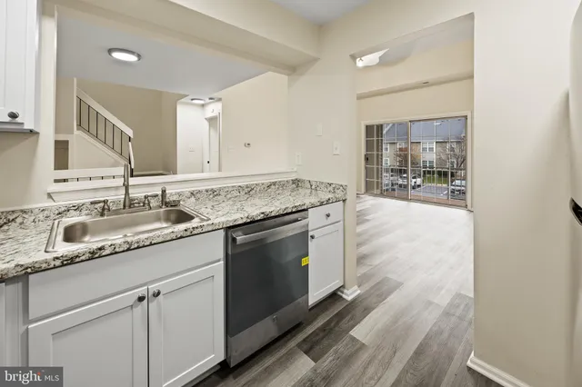 a white refrigerator freezer and a wooden floor