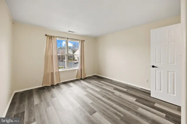 a view of room with wooden floor