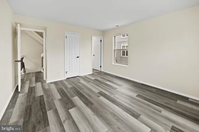a view of an empty room and wooden floor
