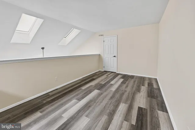 a view of room with window and wooden floor