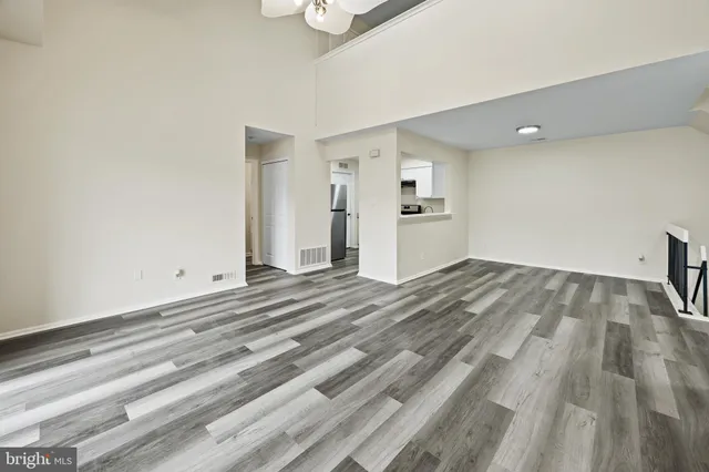 a view of empty room with wooden floor