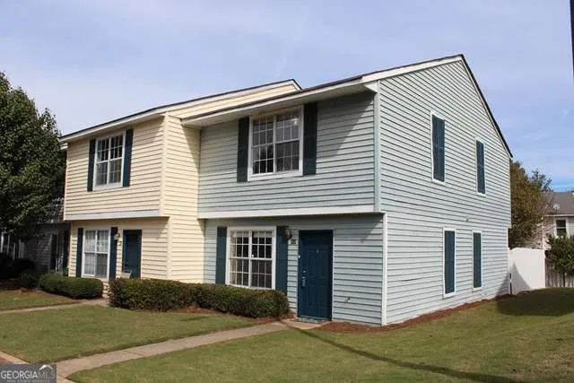 a front view of a house with a yard