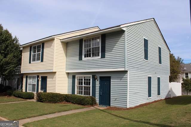 a front view of a house with a yard