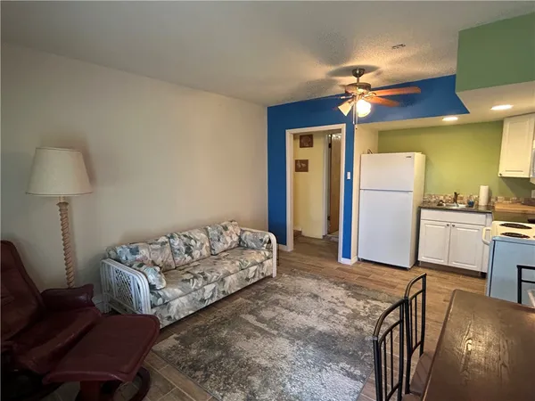 a kitchen with a refrigerator and cabinets