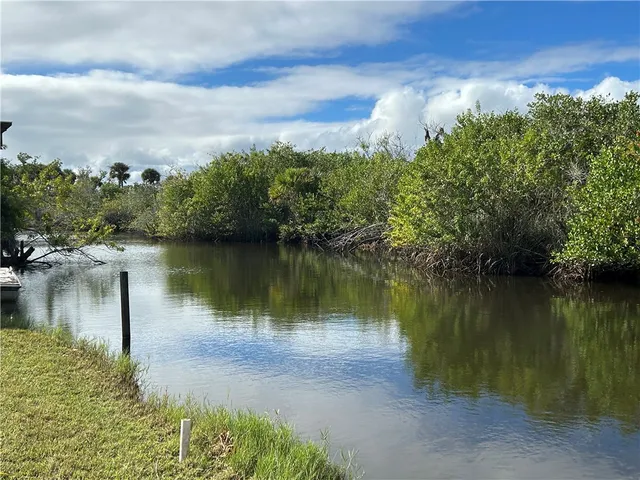 a view of a lake with houses in the back