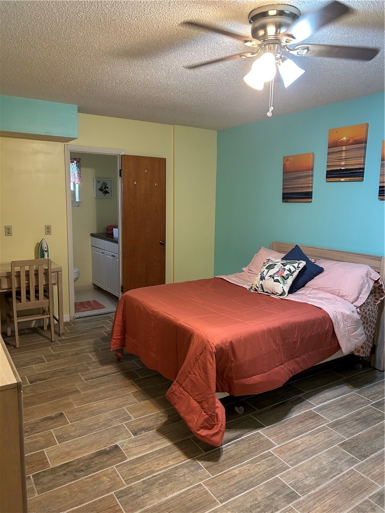 9418 Fleming Grant Road Sebastian, FL 32976 - Photo 5 of 16 a bedroom with a bed and a chandelier