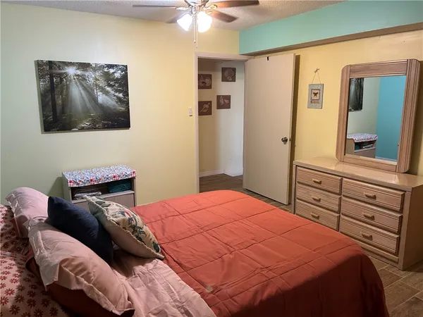 a bedroom with a bed and a painting on the wall