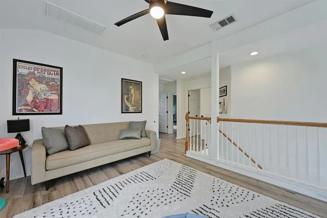 a bedroom with a bed a window and a flat screen tv