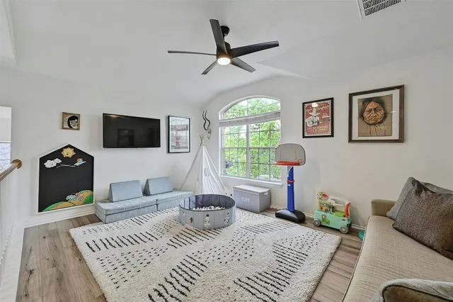 a bedroom with bed and wooden floor