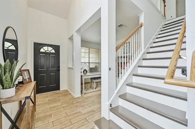 a view of entryway and hall with wooden floor