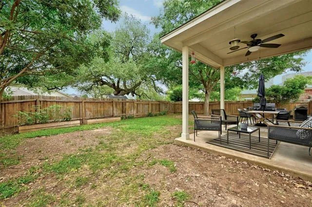 a view of a patio with a table and chairs