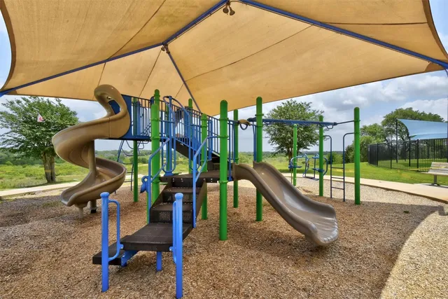a view of a garden with a tree in the background