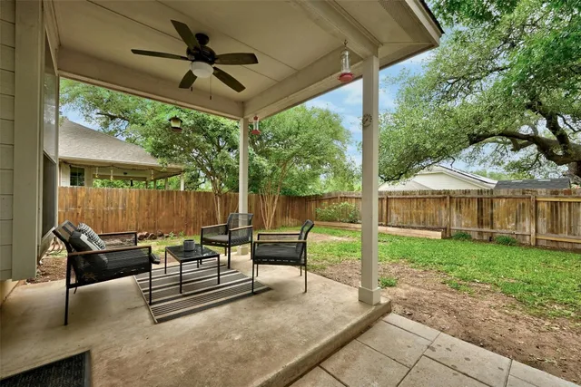 a view of a patio with a table chairs and a yard