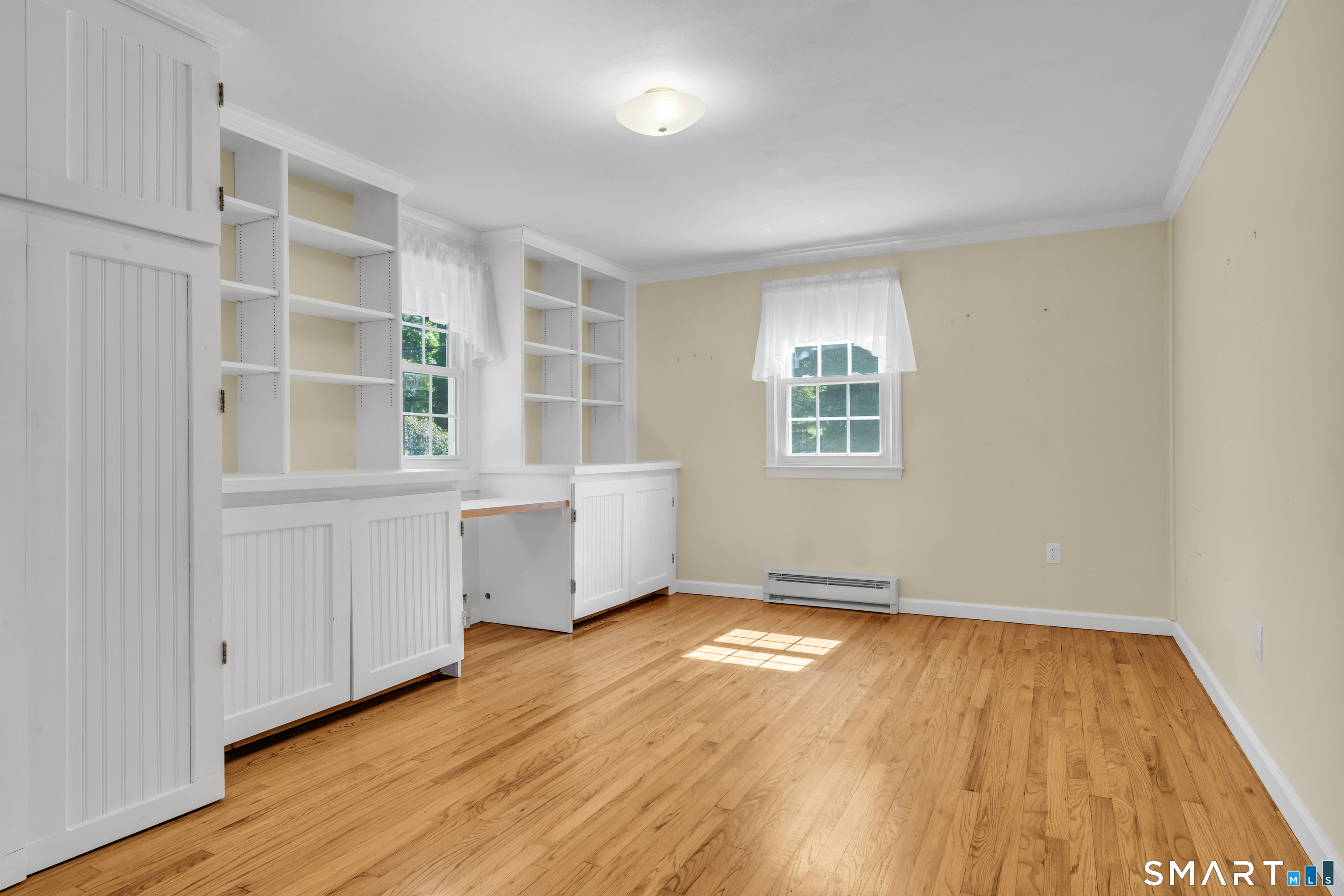 110 Nut Plains Road Guilford, CT 06437 - Photo 20 of 40 A bedroom, a library, and a home office all in one sun filled suite.