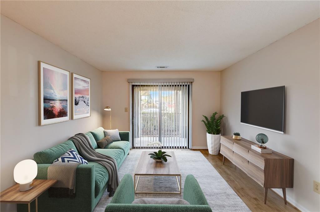 2657 Lenox Road Northeast, Unit 801 Atlanta, GA 30324 - Photo 1 of 1 a living room with furniture and a flat screen tv