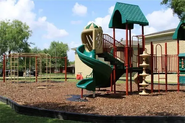 a childrens park with lots of swings and slides