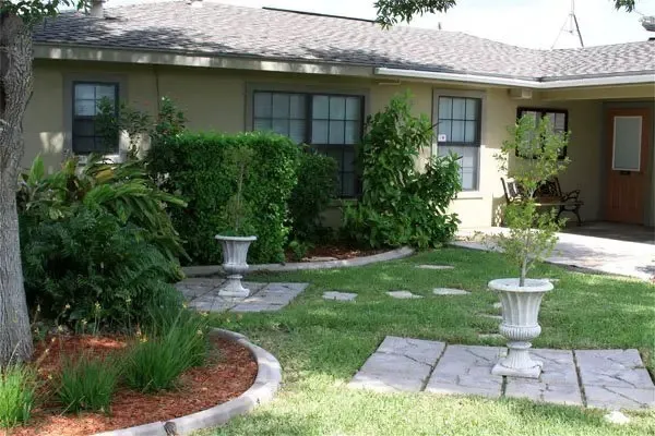 a front view of a house with garden