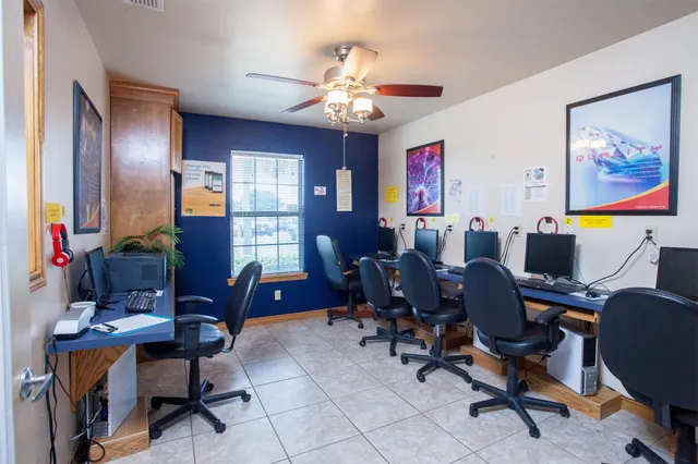 a view of a workspace with furniture and a window