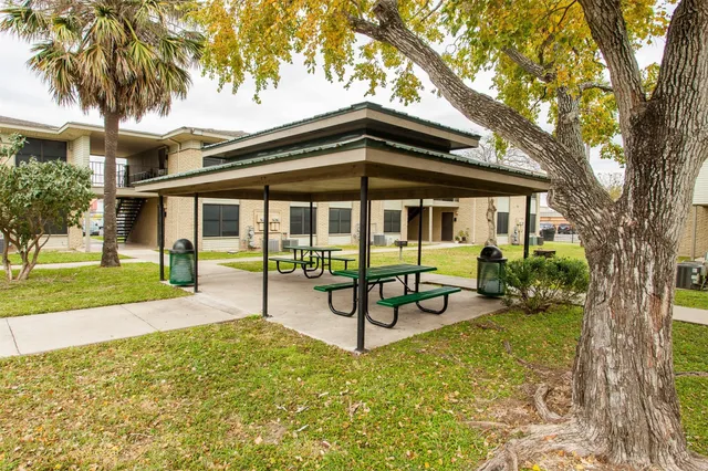 a view of a house with backyard porch and sitting area