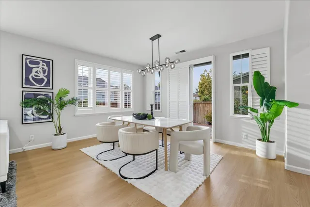 a living room with furniture kitchen and a chandelier