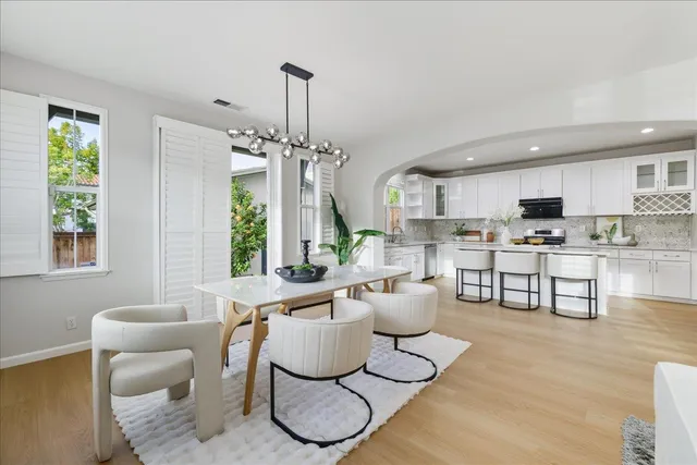a living room with furniture a dining table and kitchen view