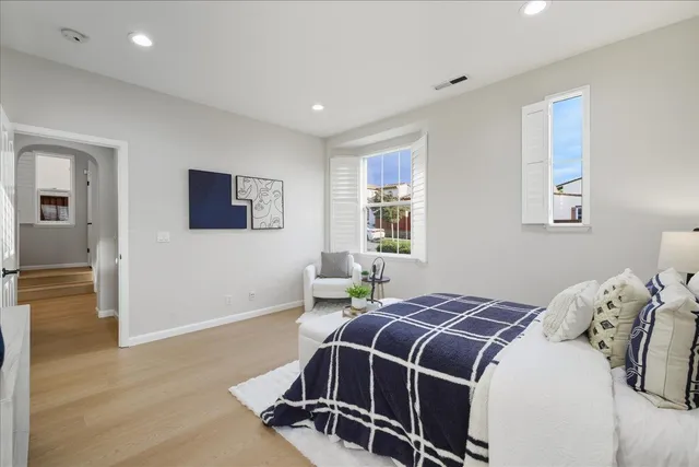 a spacious bedroom with a bed and a couch