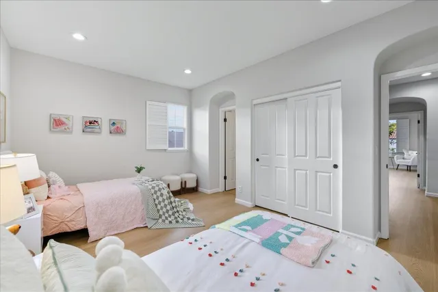 a bedroom with a large bed and a window