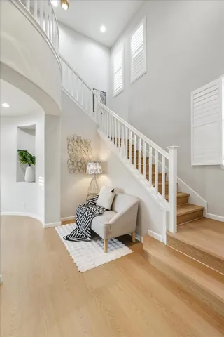 a living room with furniture and large windows