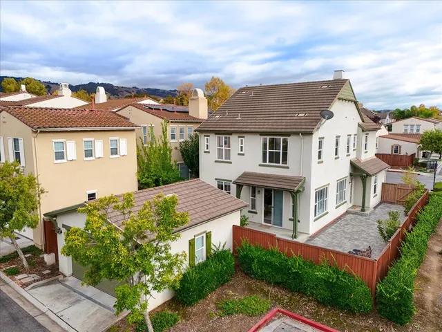 an aerial view of residential building with parking and yard